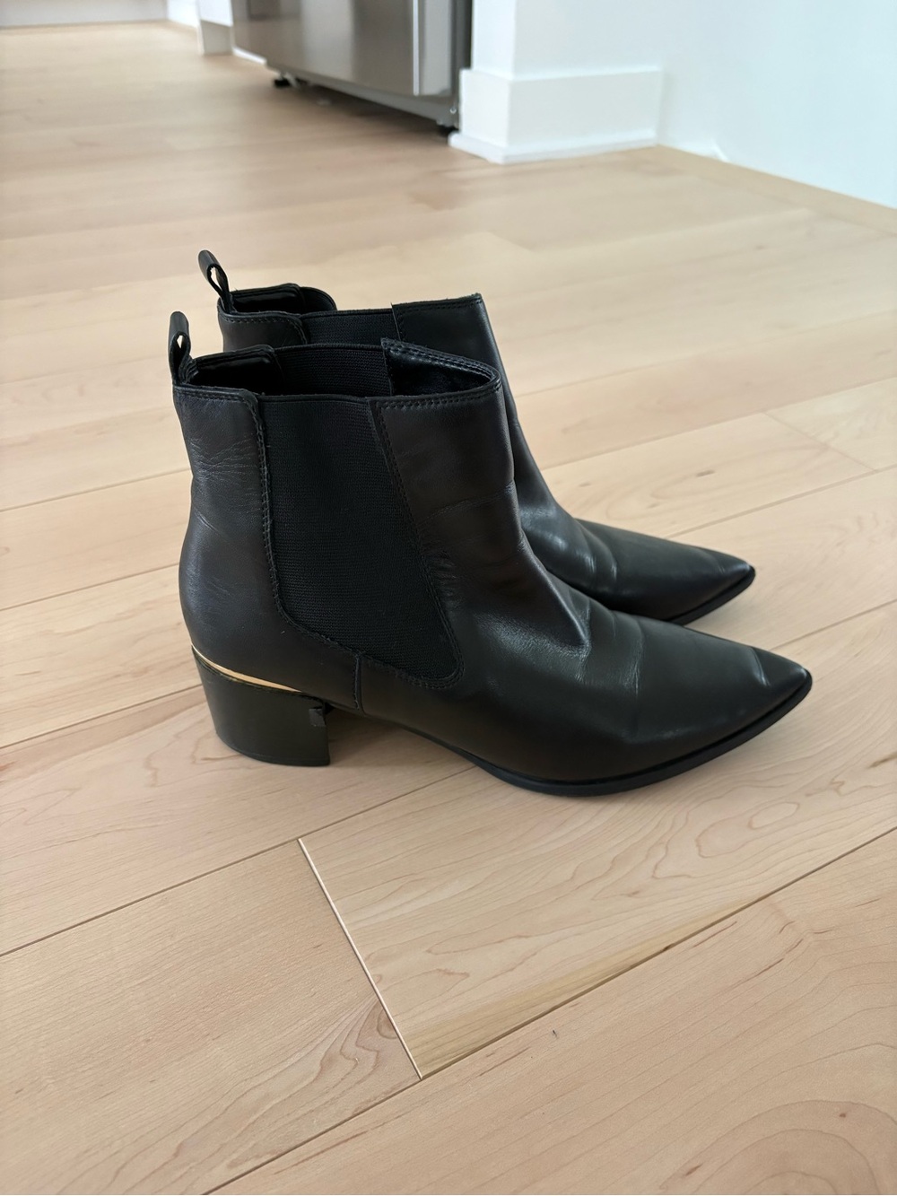 Nine West Black Pointed Chelsea Booties with Gold Heel Detail